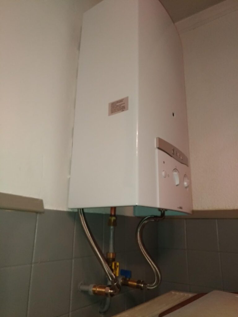 Chauffe-eau mural blanc vu de trois-quarts bas